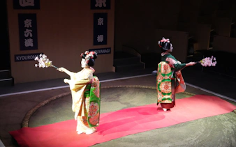 Geisha performers in traditional attire at Kyoto Sumo Entertainment Show.