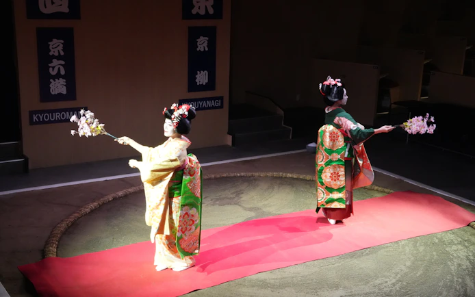 Geisha performers in traditional attire at Kyoto Sumo Entertainment Show.
