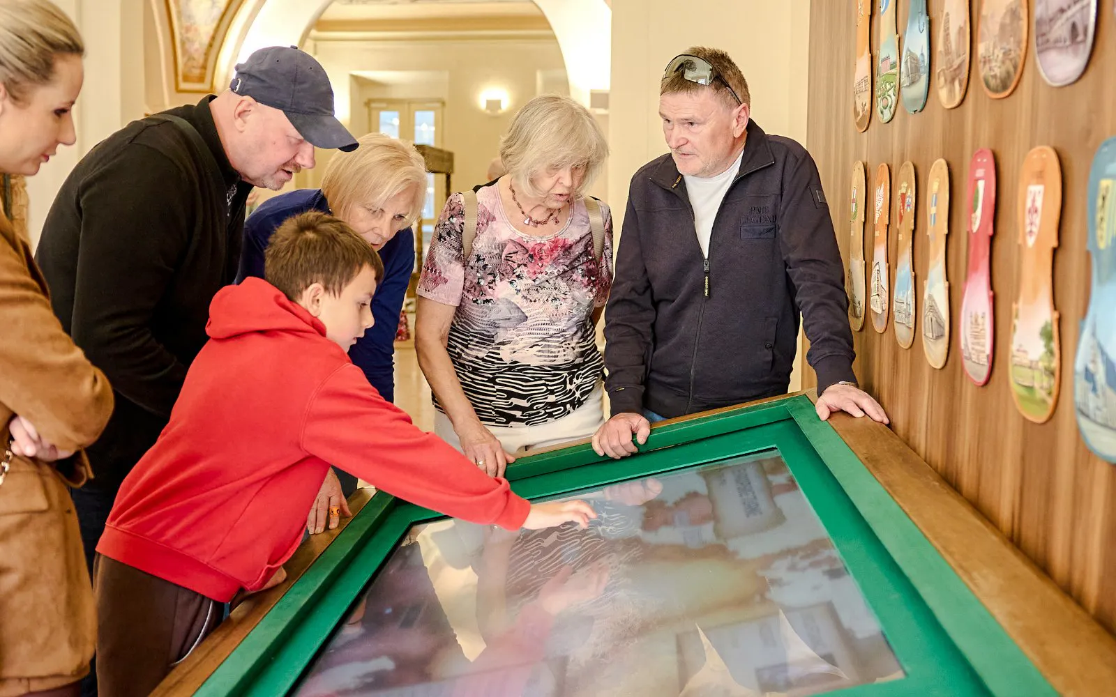Guests interacting with a digital exhibit at Mozart Interactive Museum in Prague.