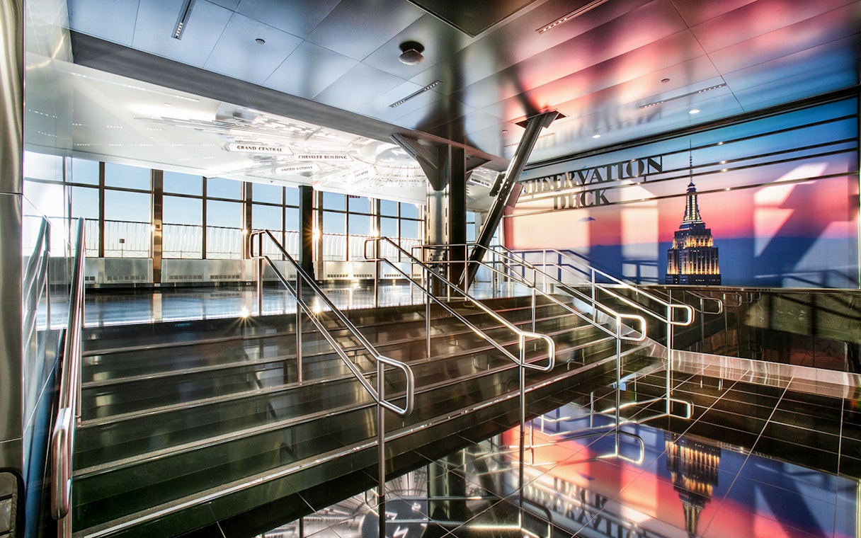 Empire State Building Observatory interior with view of New York City skyline.