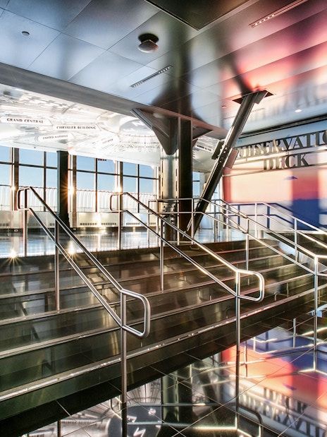 Empire State Building Observatory interior with view of New York City skyline.