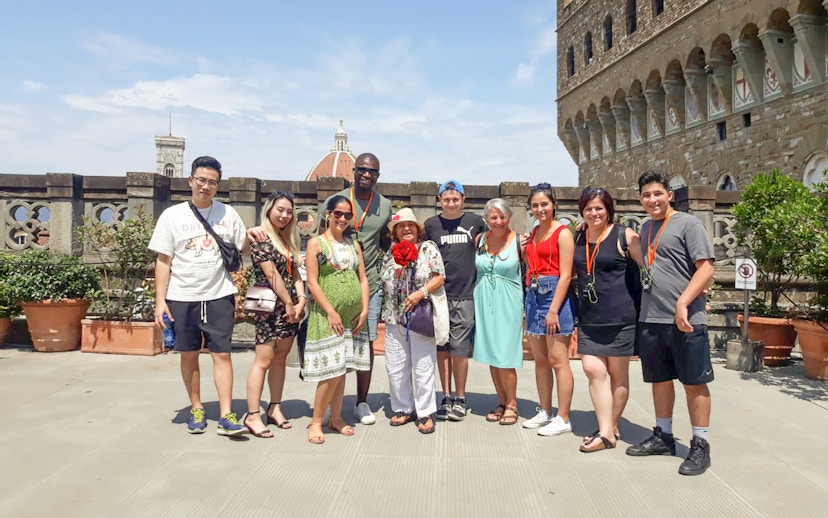 Group of tourists on a Palazzo Vecchio tour in Florence, Italy, with the Duomo in the background.