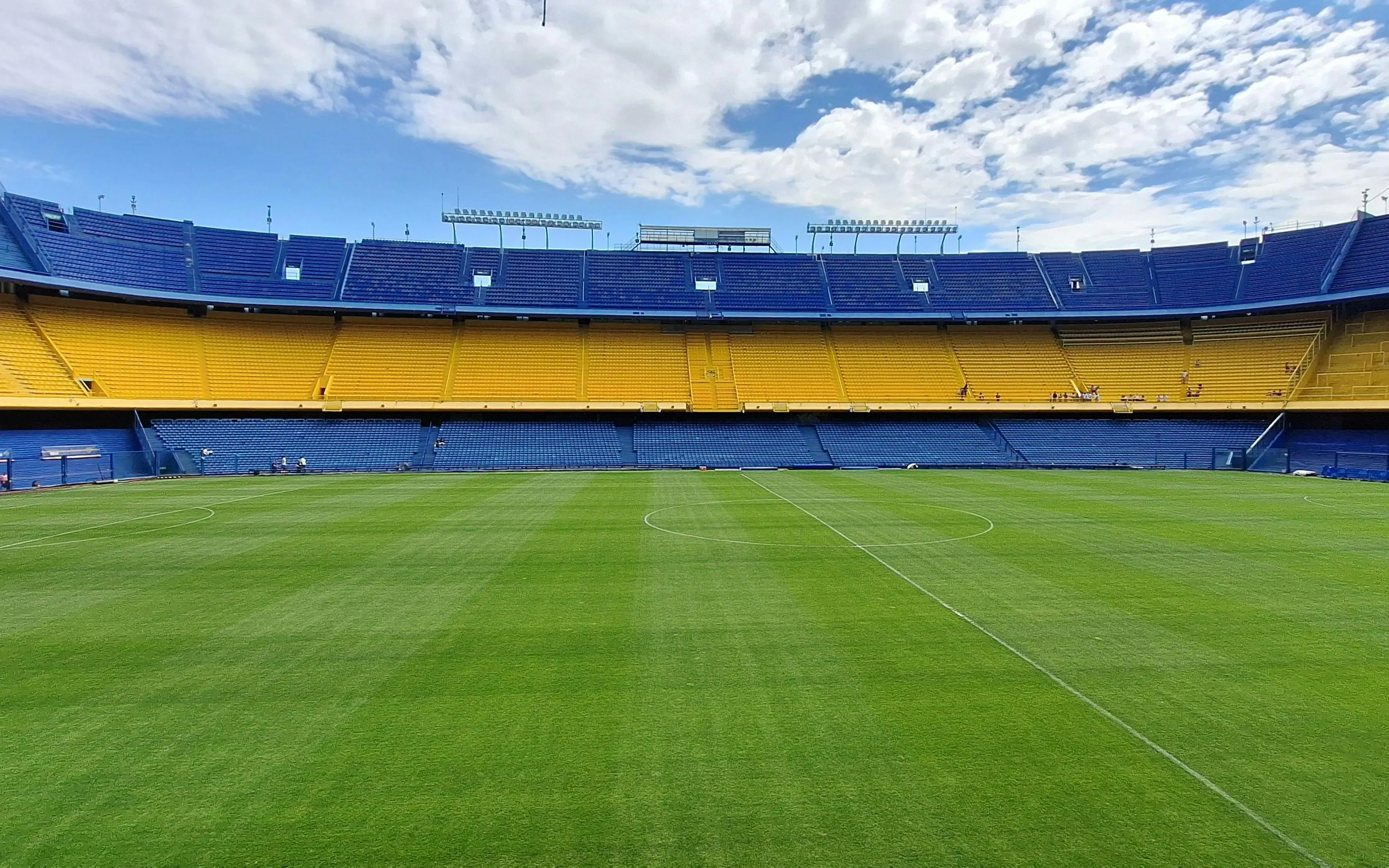 La Bombonera stadium interior with empty stands and green field, Buenos Aires.