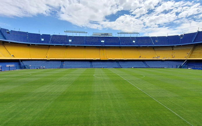 La Bombonera stadium interior with empty stands and green field, Buenos Aires.
