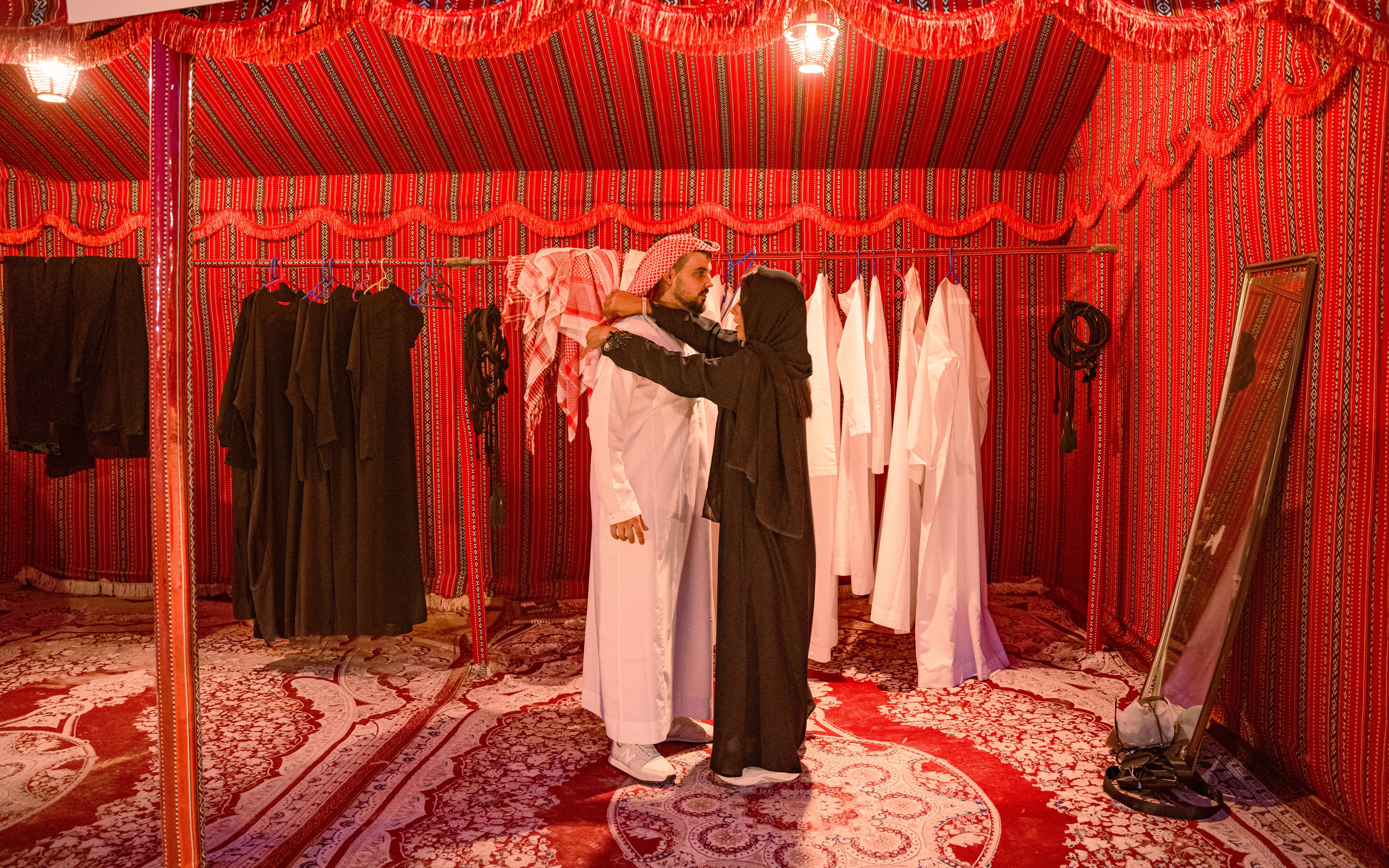 People dressing in traditional Arab attire inside a tent during a desert safari in Abu Dhabi.