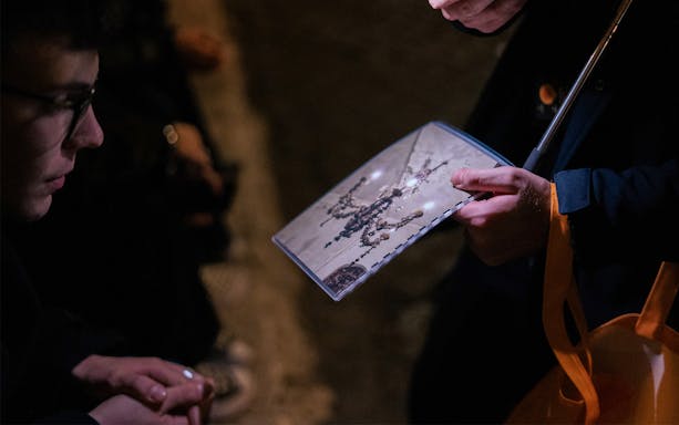 Local guide showing map during Haunted Ghosts Tour in Rome.