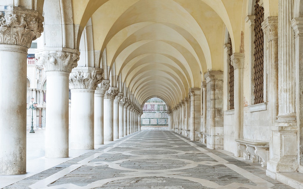 Archway with columns under Doge's Palace in San Marco Square, Venice.