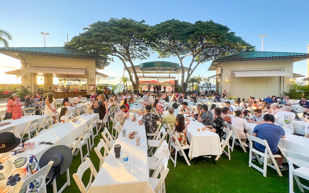 Guests seated at tables during a traditional Hawaiian luau at Moana Luau, Hawaii.