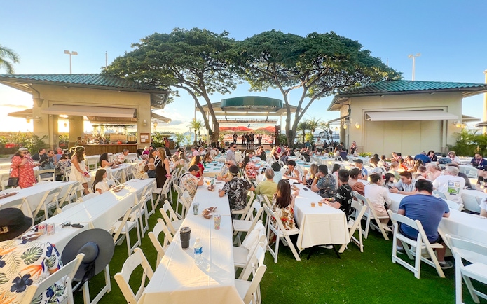 Guests seated at tables during a traditional Hawaiian luau at Moana Luau, Hawaii.