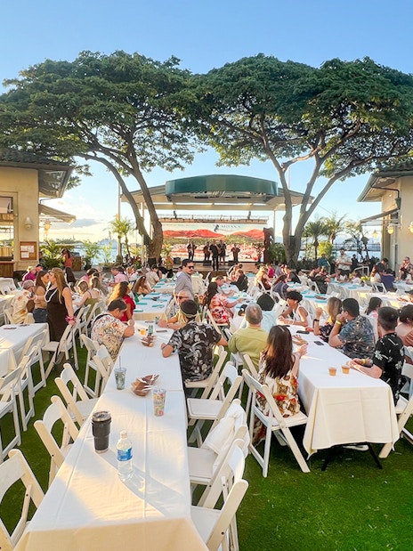 Guests seated at tables during a traditional Hawaiian luau at Moana Luau, Hawaii.