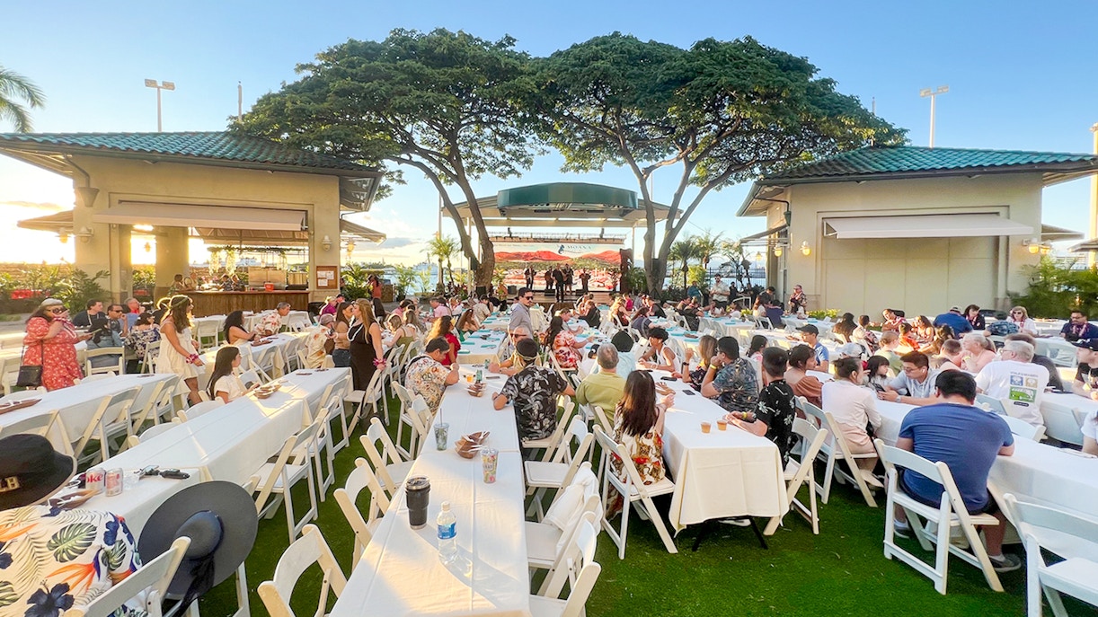 Guests seated at tables during a traditional Hawaiian luau at Moana Luau, Hawaii.