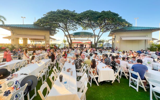 Guests seated at tables during a traditional Hawaiian luau at Moana Luau, Hawaii.