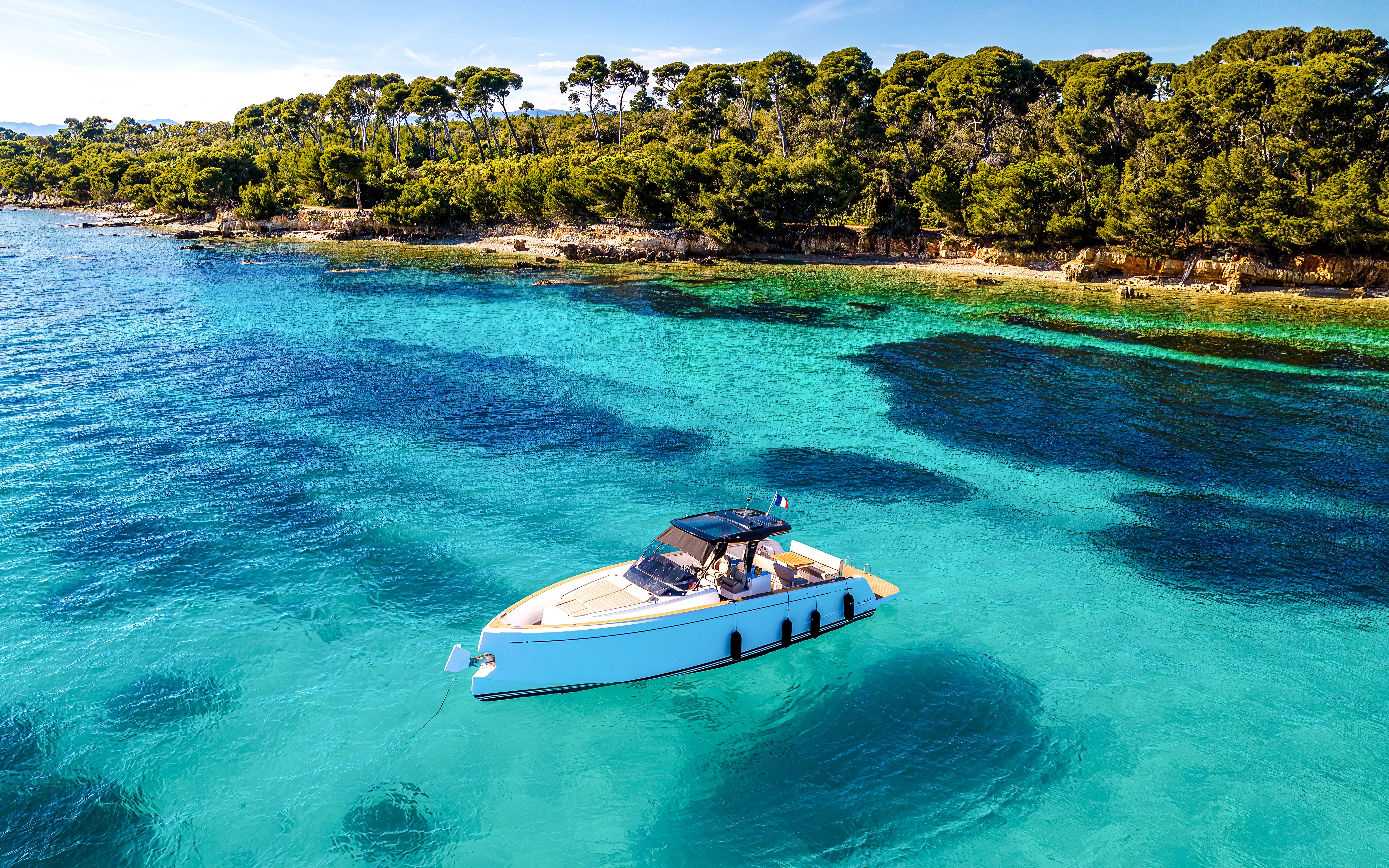 Private boat on turquoise waters near Lérins Islands, Cannes.