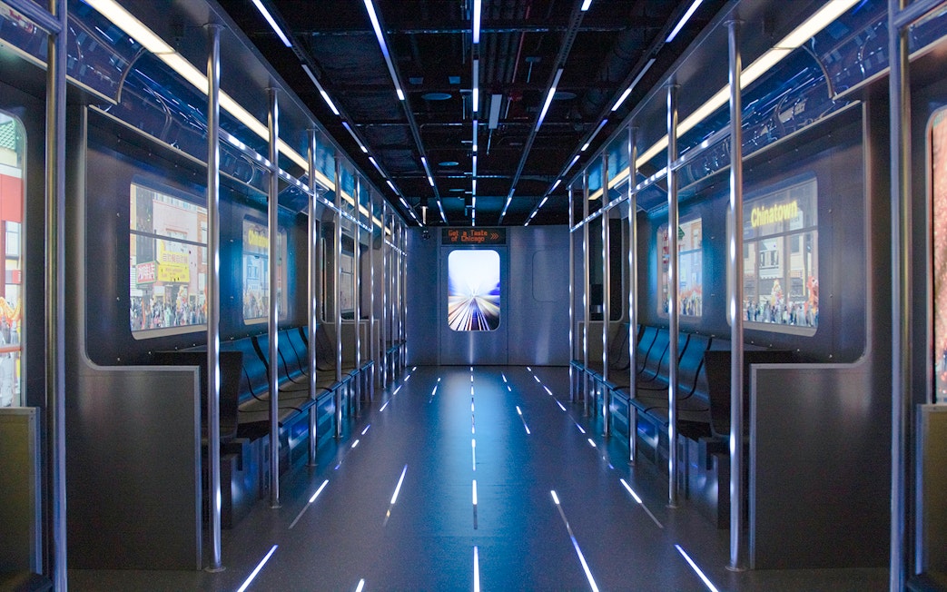 Replica of the L train interior at Skydeck Chicago with cityscape views.