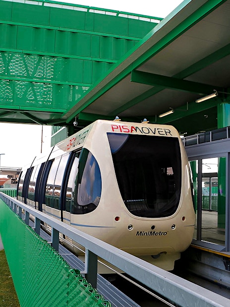 Pisamover Mini Metro at Pisa Airport terminal gate for city transfer.