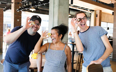 Guests enjoying donuts at a cafe, posing playfully with them.