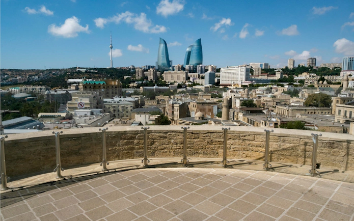 View from Maiden Tower Museum overlooking Baku cityscape with Flame Towers in the distance.