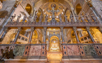 St. Mark's Basilica interior with ornate columns and statues, Venice, Italy.