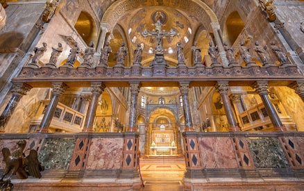 St. Mark's Basilica interior with ornate columns and statues, Venice, Italy.