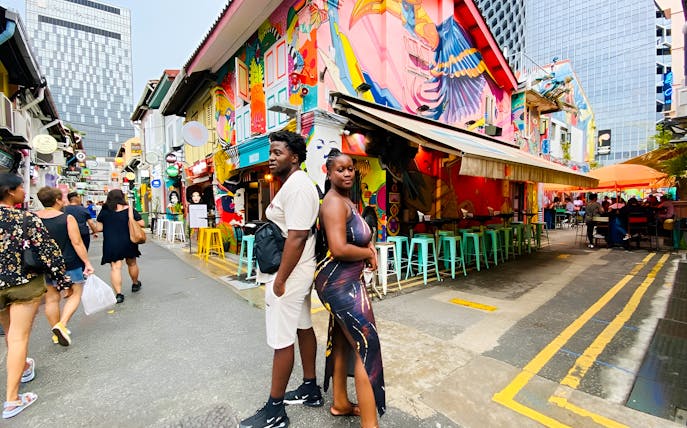 Colorful street art and people in Kampong Gelam, Singapore, during a guided city highlights tour.
