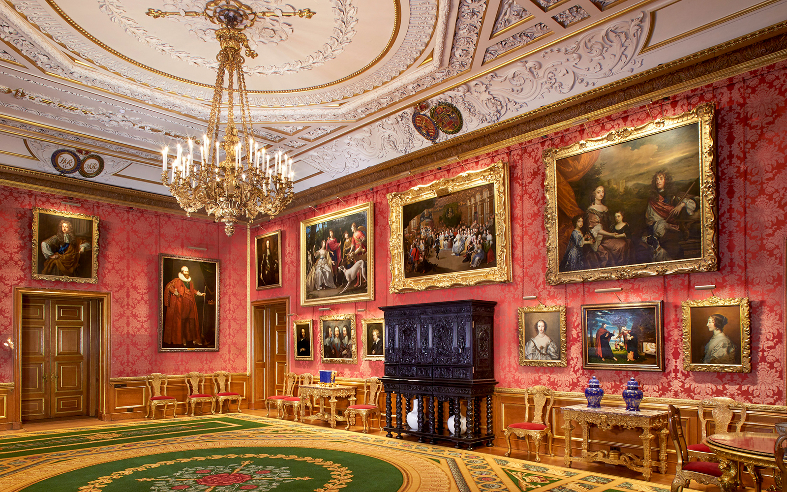 Queen's Drawing Room in Windsor Castle with ornate ceiling, chandelier, and classic paintings.