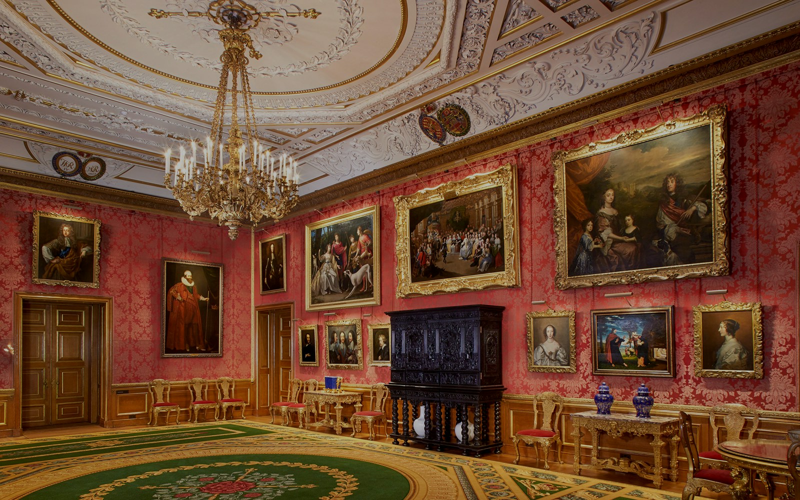 Queen's Drawing Room in Windsor Castle with ornate ceiling, chandelier, and classic paintings.