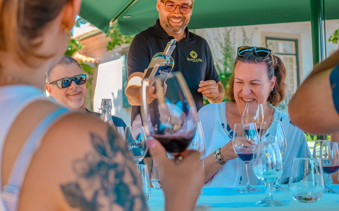 Tourists enjoying wine tasting at a Douro Valley restaurant.