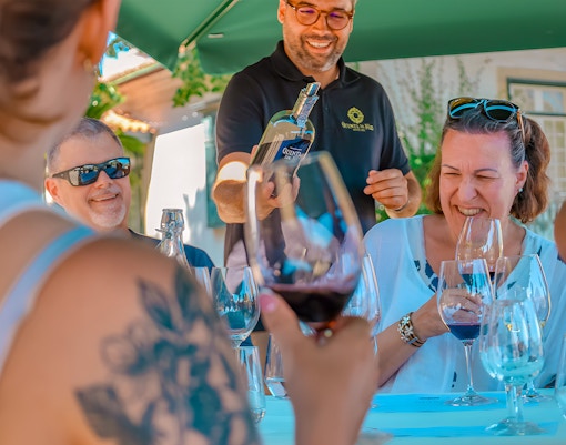 Tourists enjoying wine tasting at a Douro Valley restaurant.