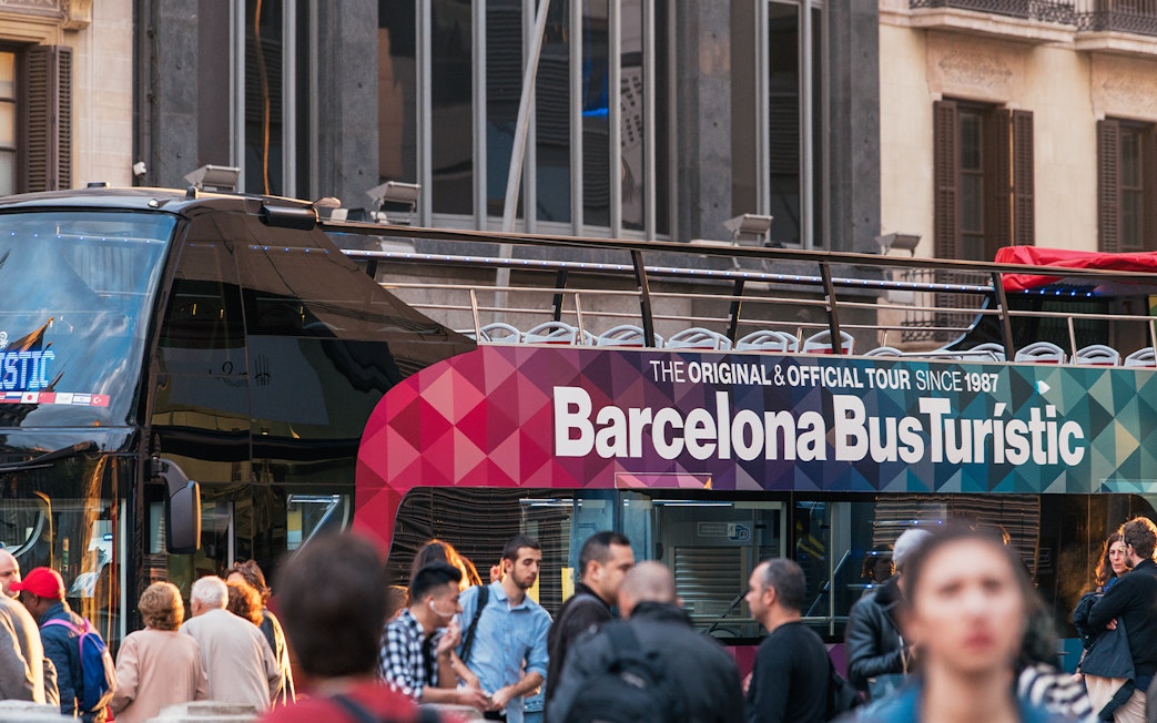 Barcelona Bus Turistic with passengers boarding for a city tour.