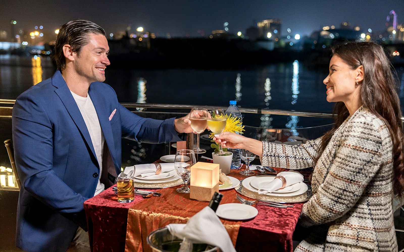 Couple dining on a luxury dhow cruise along Dubai Water Canal.