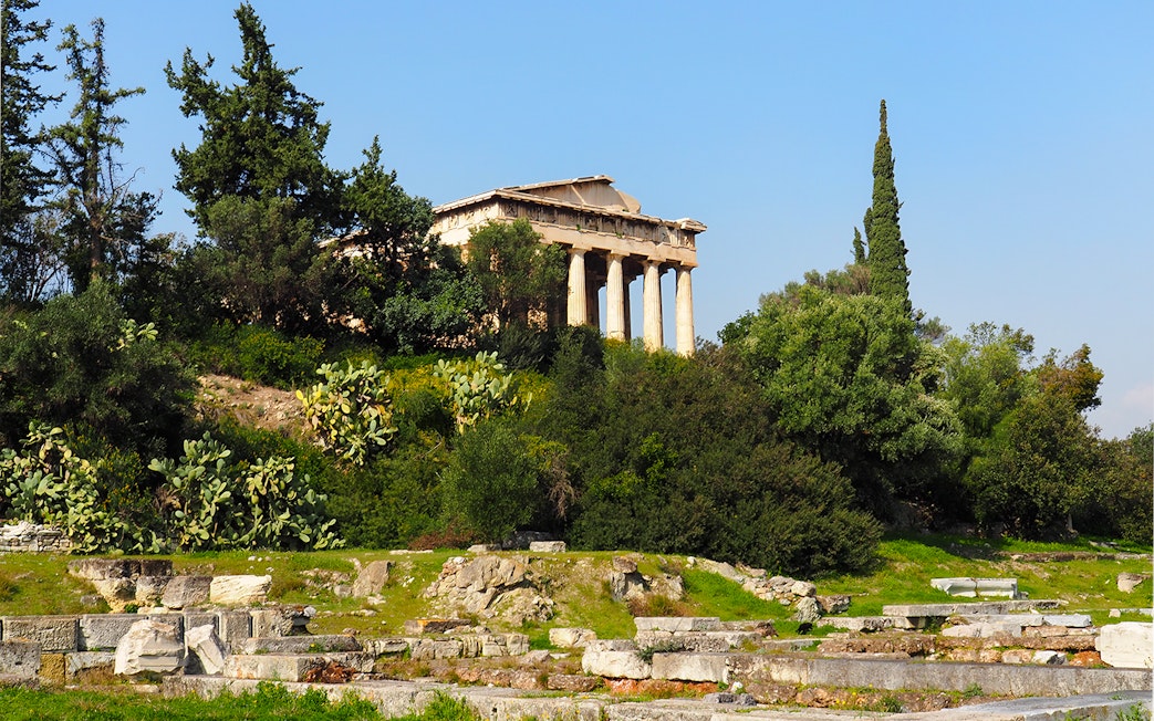 Temple of Hephaestus surrounded by greenery in Ancient Agora, Athens, Greece.