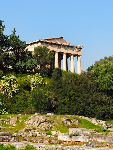 Temple of Hephaestus surrounded by greenery in Ancient Agora, Athens, Greece.