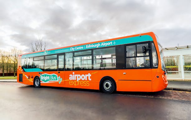 Bright orange bus labeled "Bright Bus" for Edinburgh Airport express service.