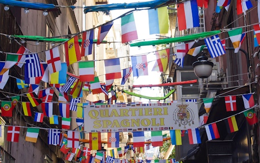 Quartieri Spagnoli street with colorful flags in Naples, Italy.