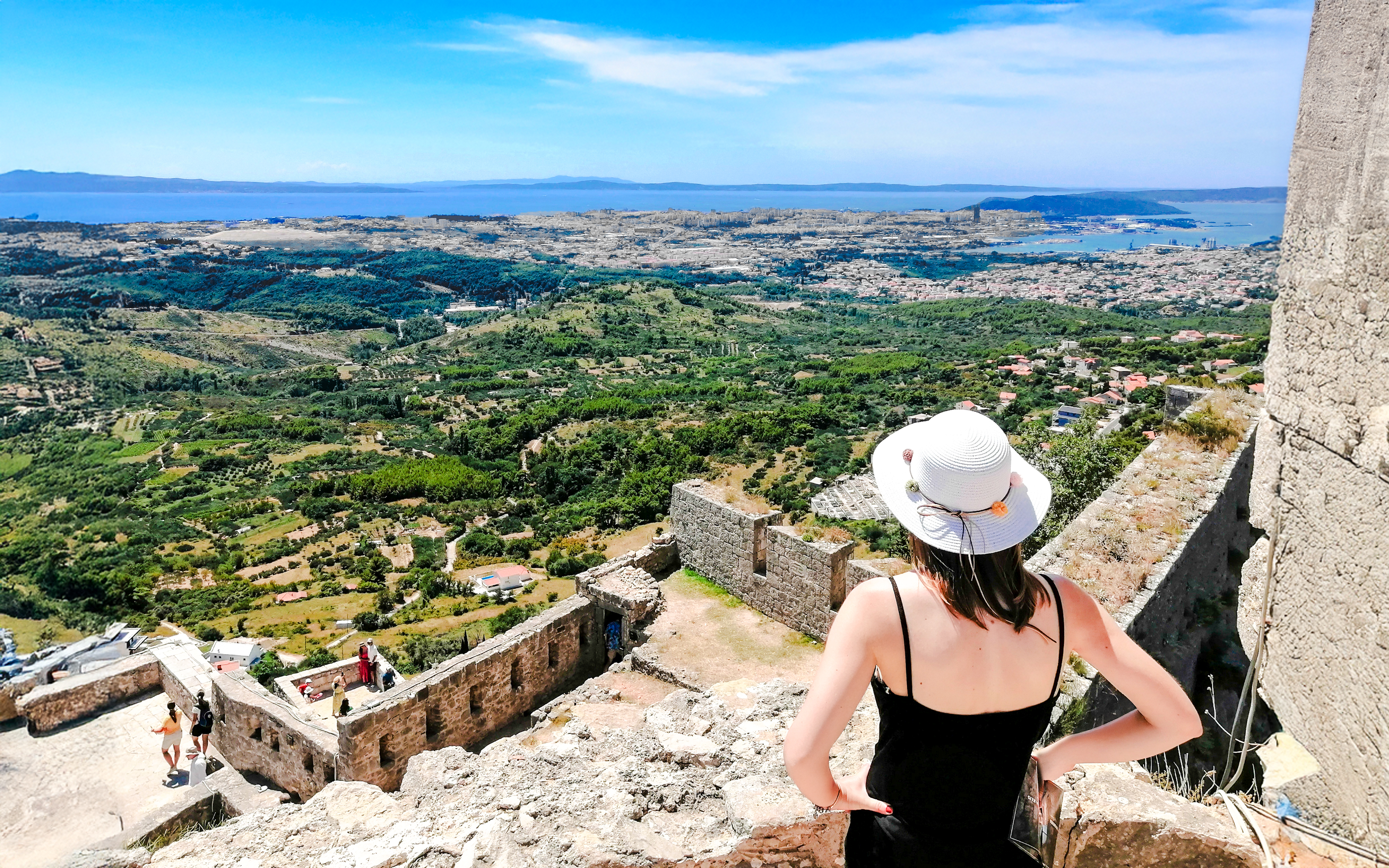 Panoramic view from Klis Fortress with tourist overlooking Split, Croatia.