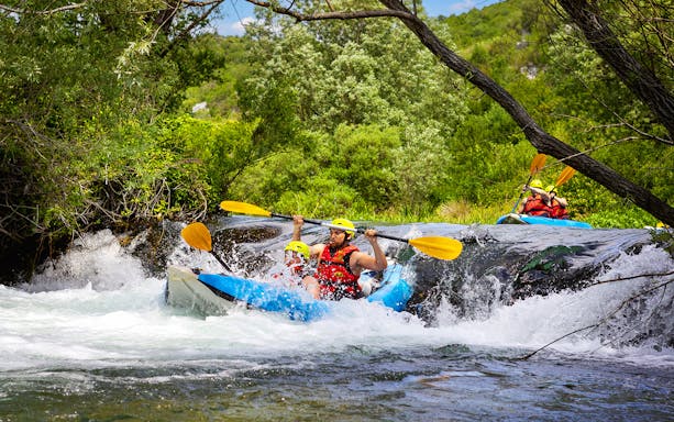 Canyoning adventure with kayakers navigating rapids near Split.
