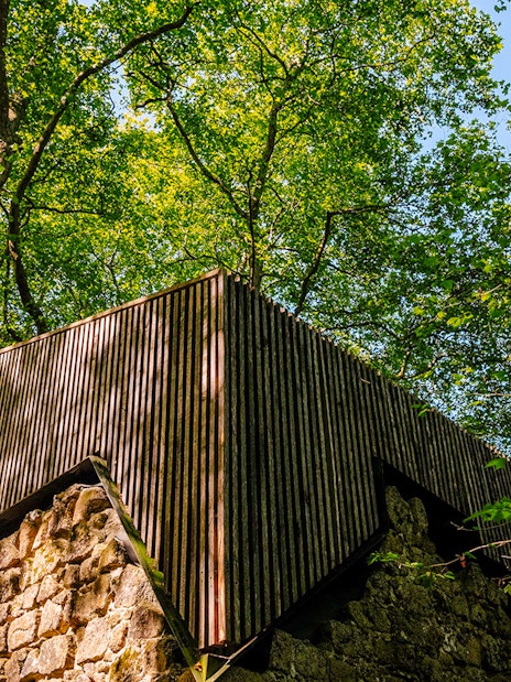 Moorish Castle ruins with Church of São Pedro de Canaferrim in Sintra, Portugal, surrounded by trees.