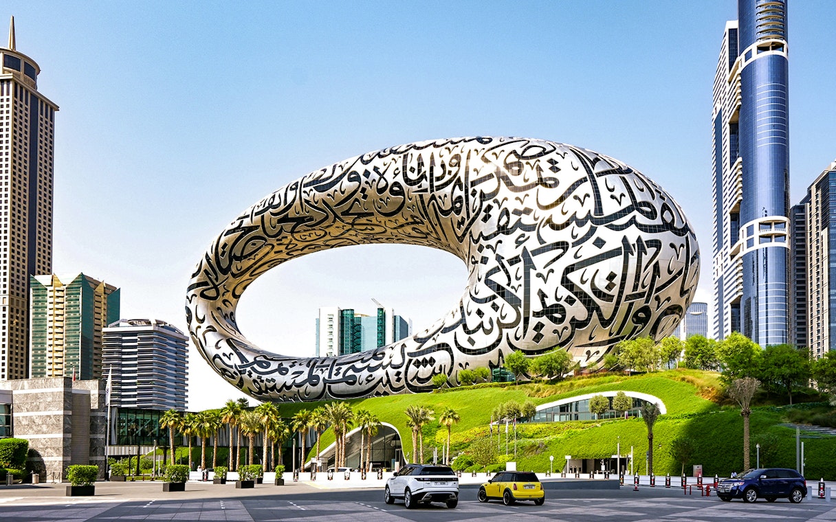 Museum of the Future in Dubai with Arabic calligraphy facade and surrounding skyscrapers.