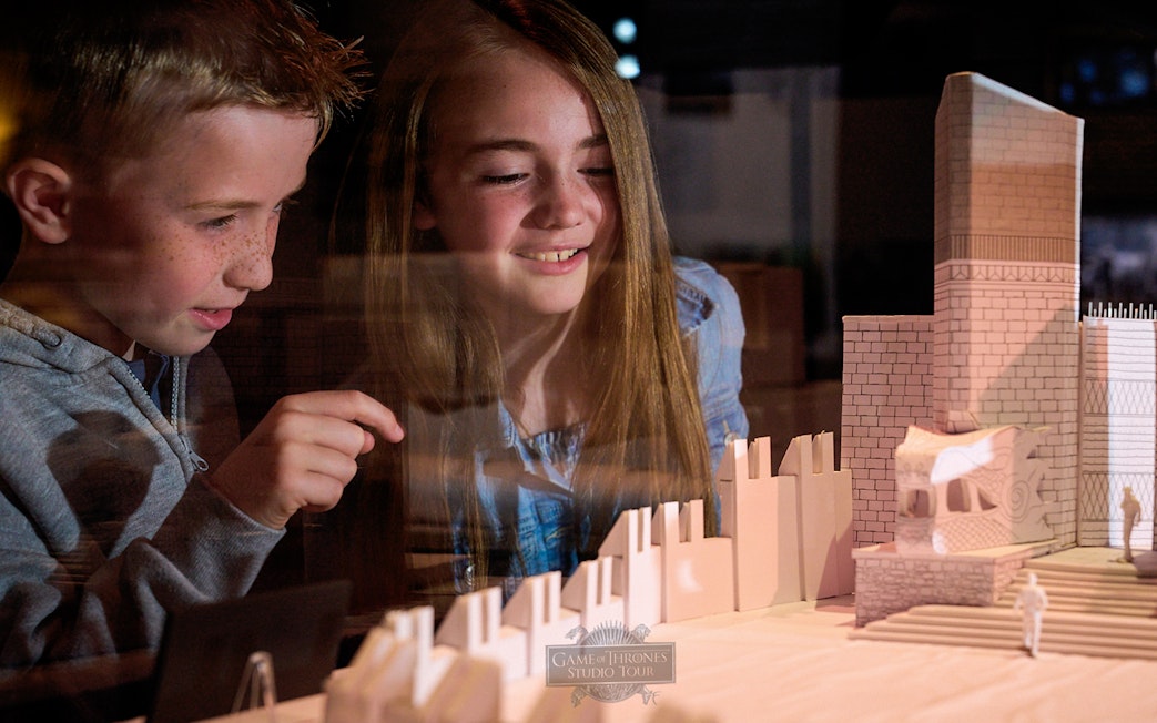 Children observing a Game of Thrones set model at the studio tour.