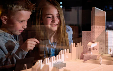 Children observing a Game of Thrones set model at the studio tour.