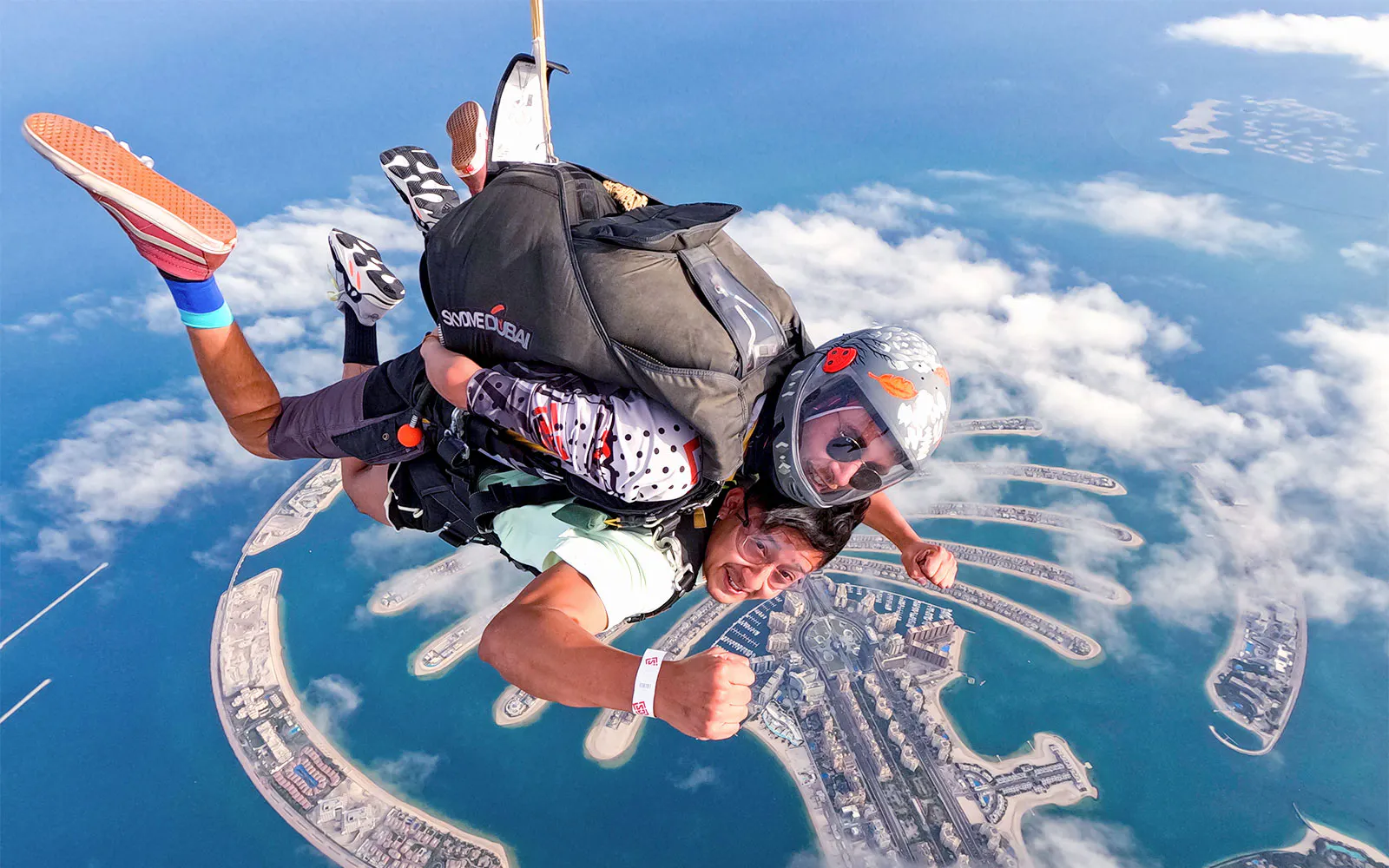 A tandem skydiver and instructor descend above Palm Jumeirah during Skydive Dubai at The Palm.