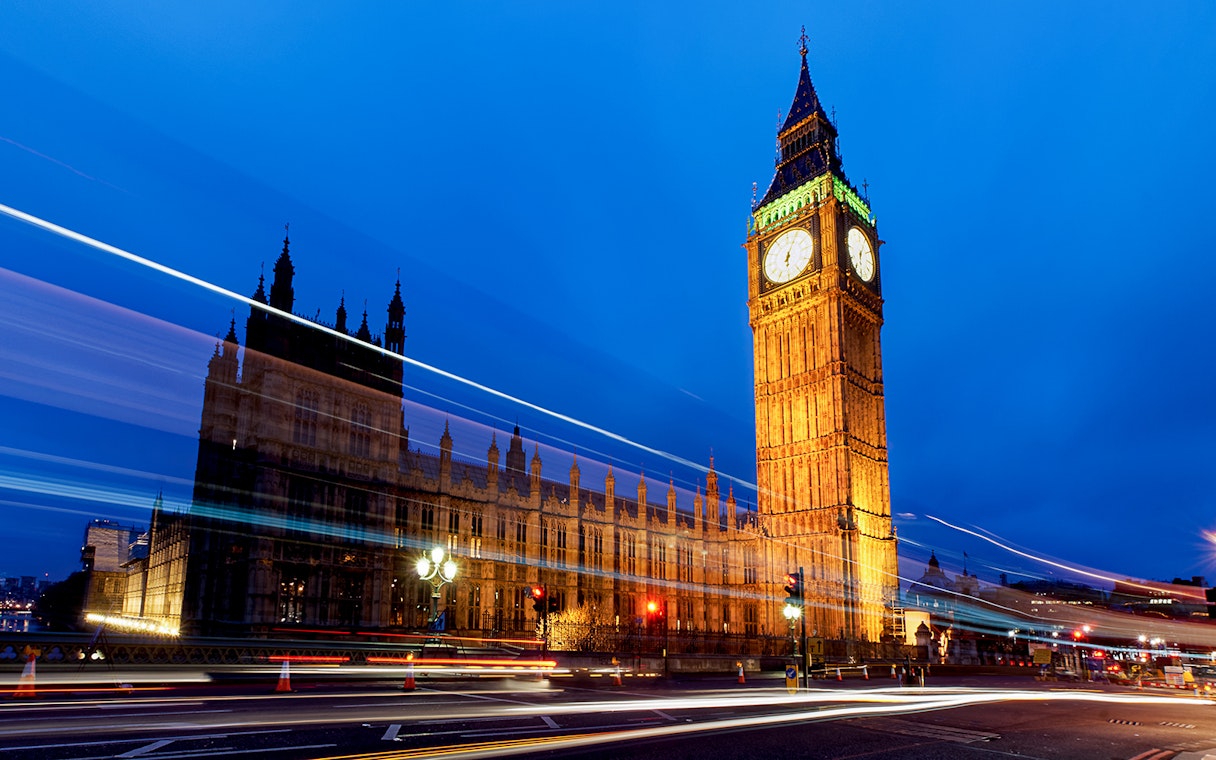 Big Ben and Houses of Parliament illuminated at night, London, viewed from a moving bus.