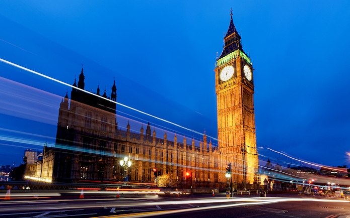 Big Ben and Houses of Parliament illuminated at night, London, viewed from a moving bus.