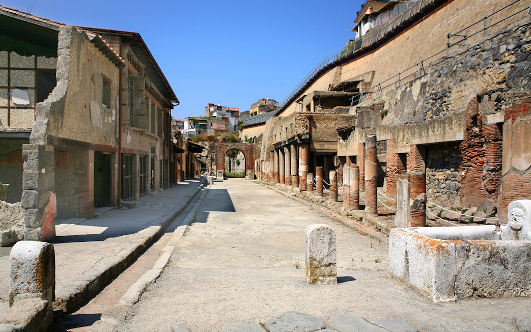 Ancient street with ruins and columns in Herculaneum, Italy.