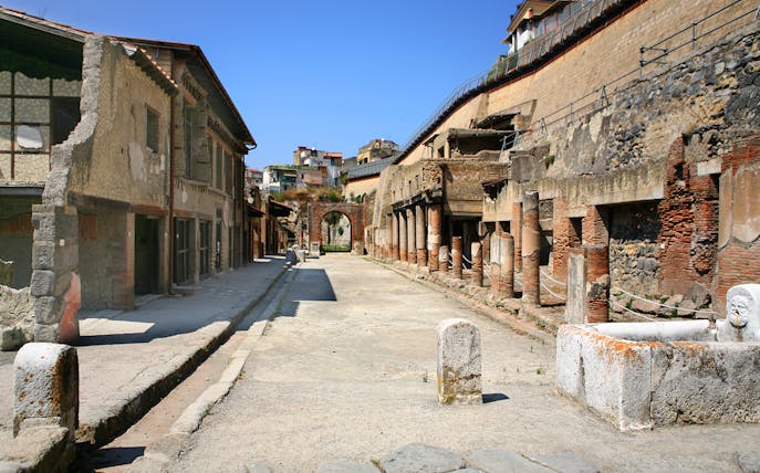 Ancient street with ruins and columns in Herculaneum, Italy.