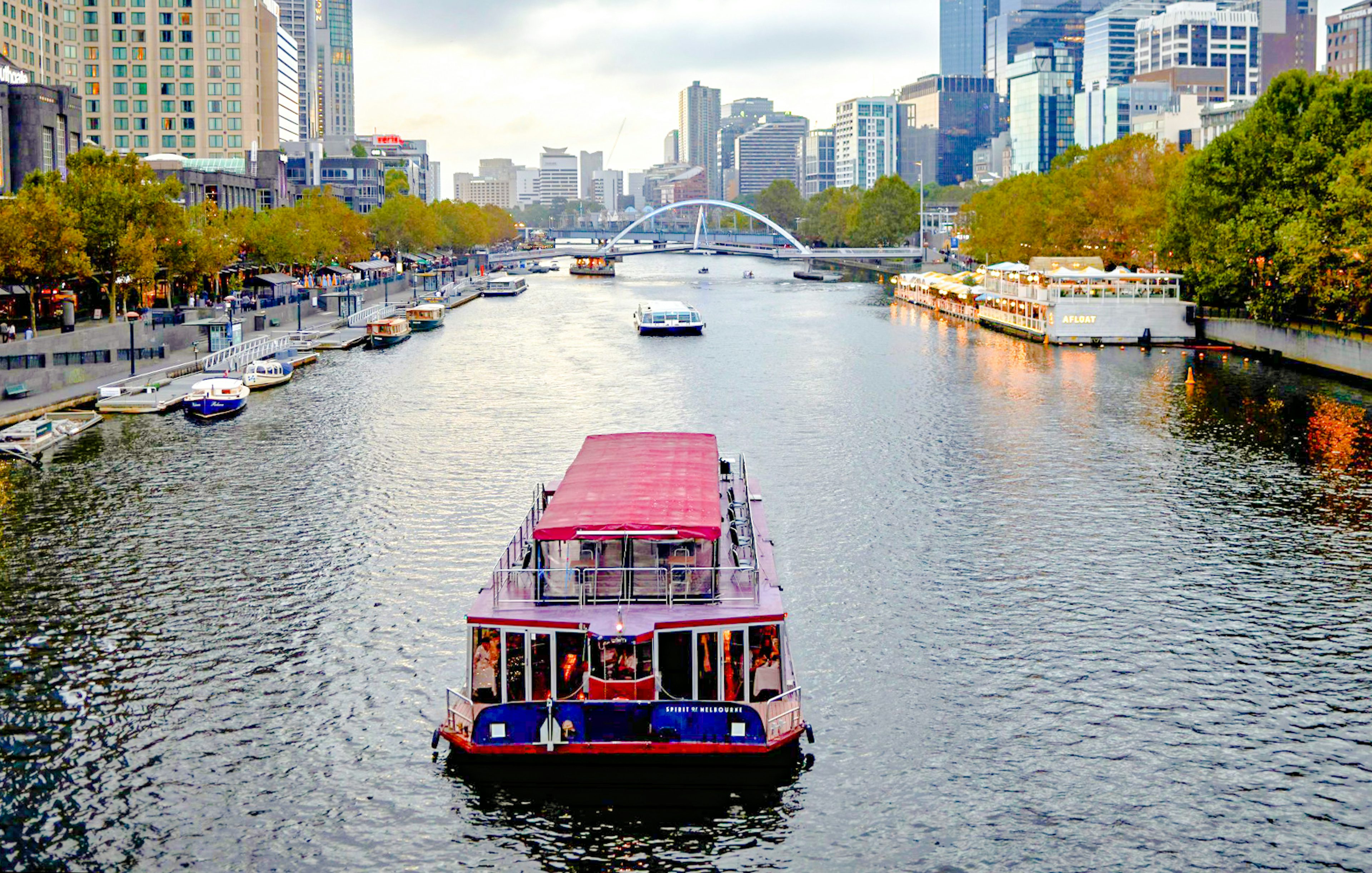 Cruise boat on Yarra River with Melbourne skyline in the background.