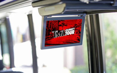 TMZ Hollywood Tour screen inside bus showing celebrity hotspots.