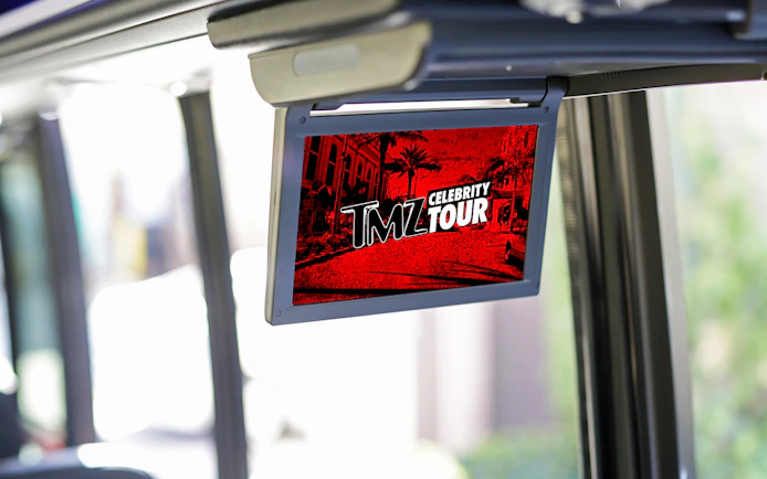 TMZ Hollywood Tour screen inside bus showing celebrity hotspots.