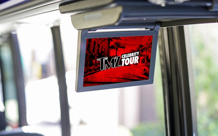 TMZ Hollywood Tour screen inside bus showing celebrity hotspots.