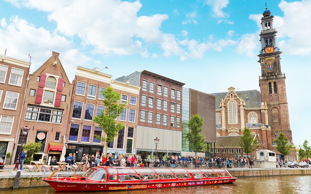 Hop-on hop-off boat near Westerkerk church in Amsterdam.